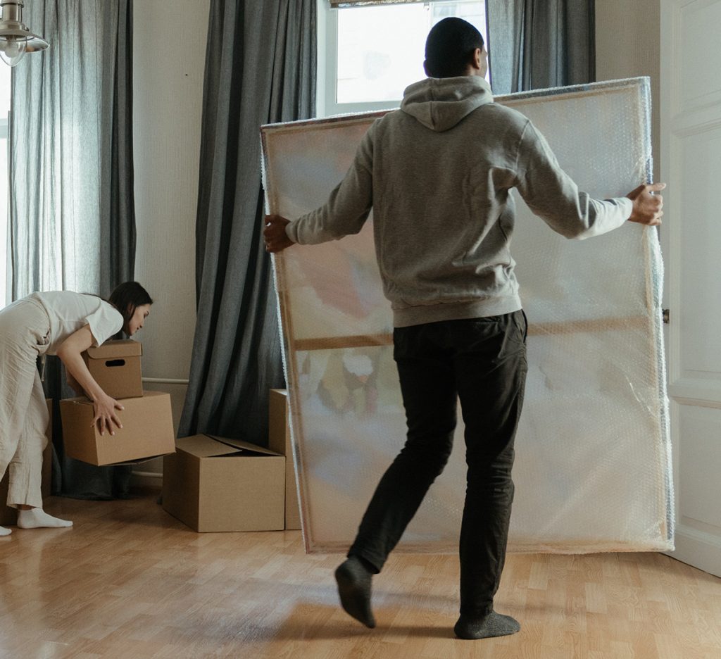 Complementary services - Man moving packed painting